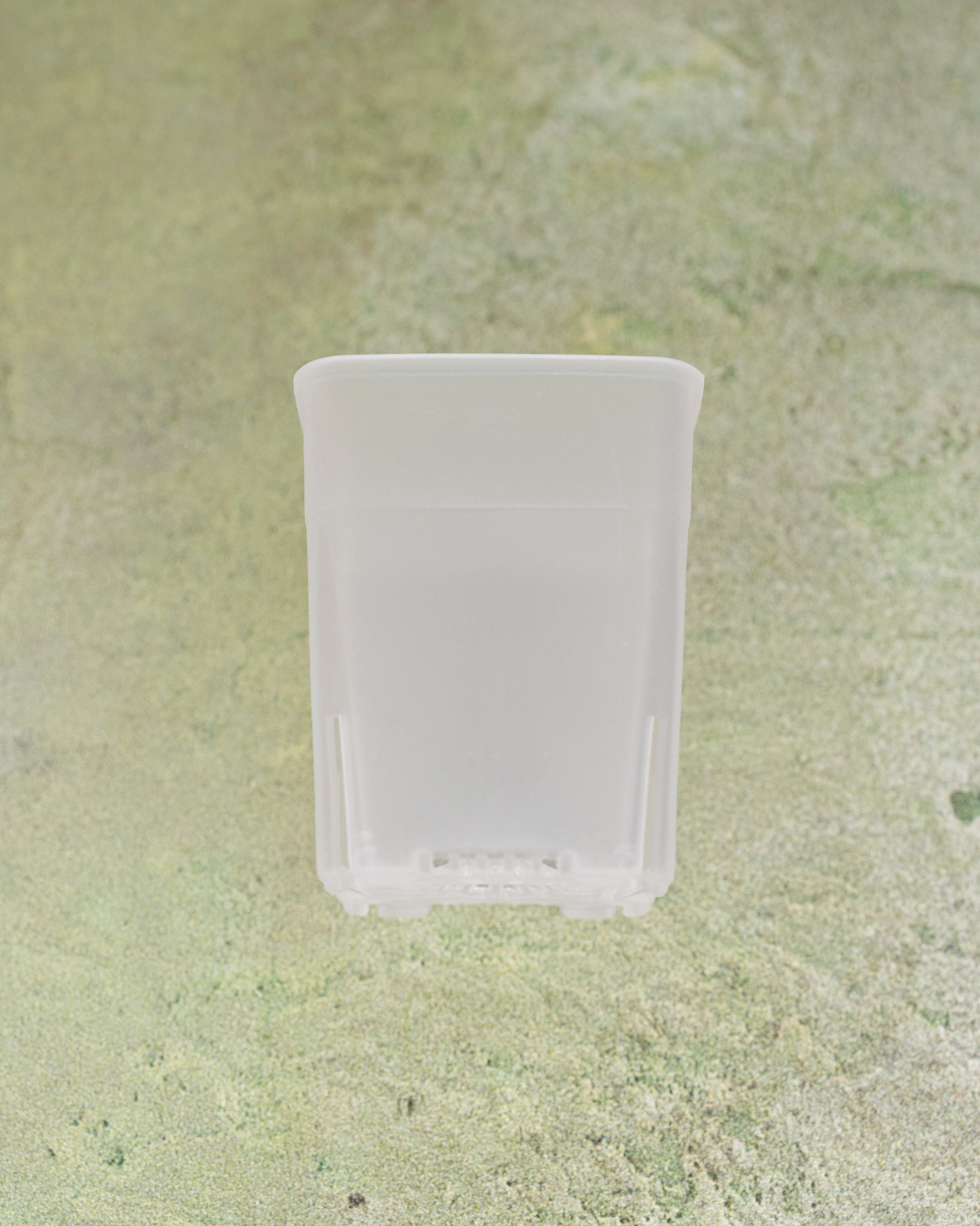 White plastic container on a textured green surface