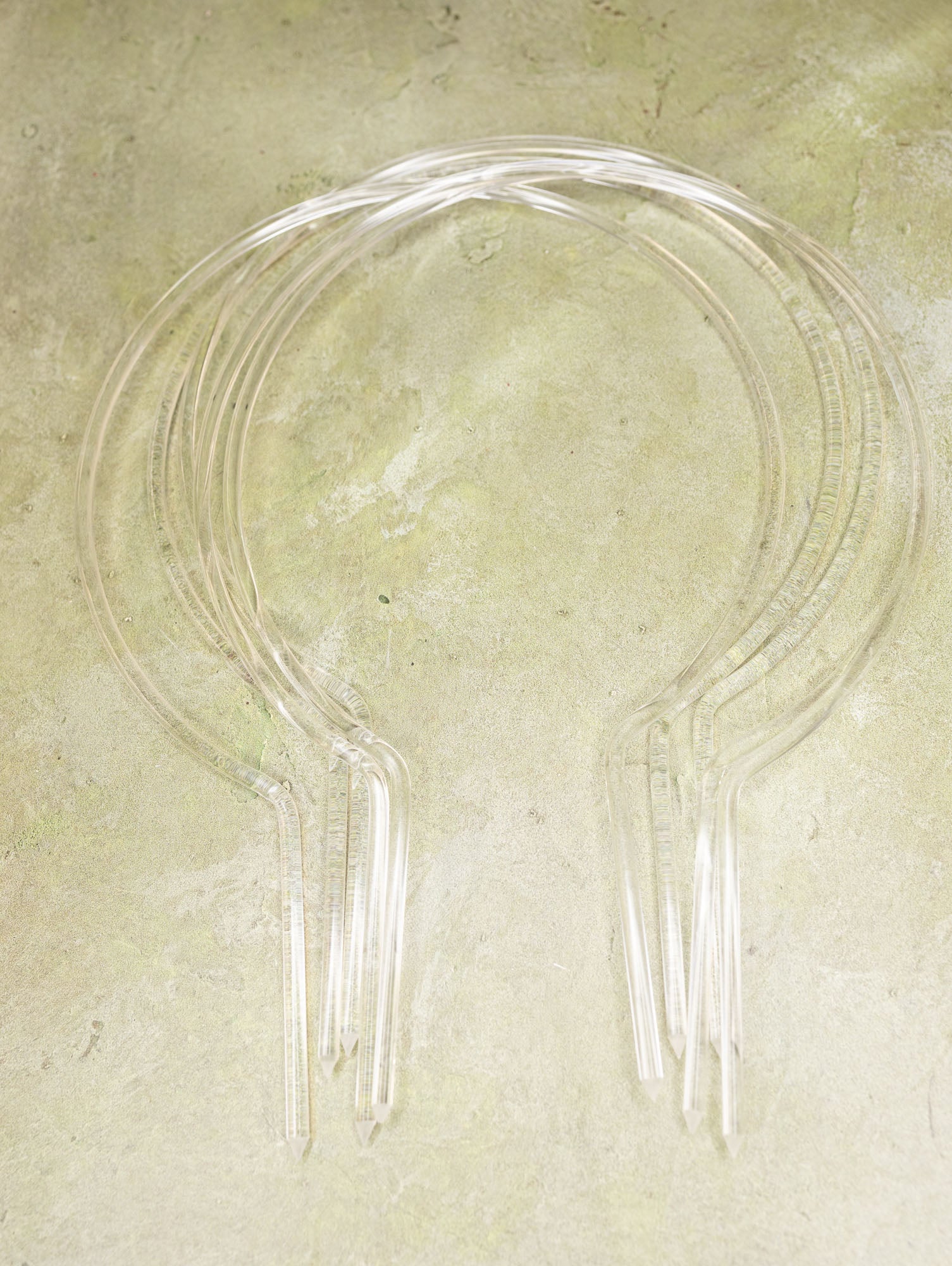 Clear acrylic trellises on a textured beige surface