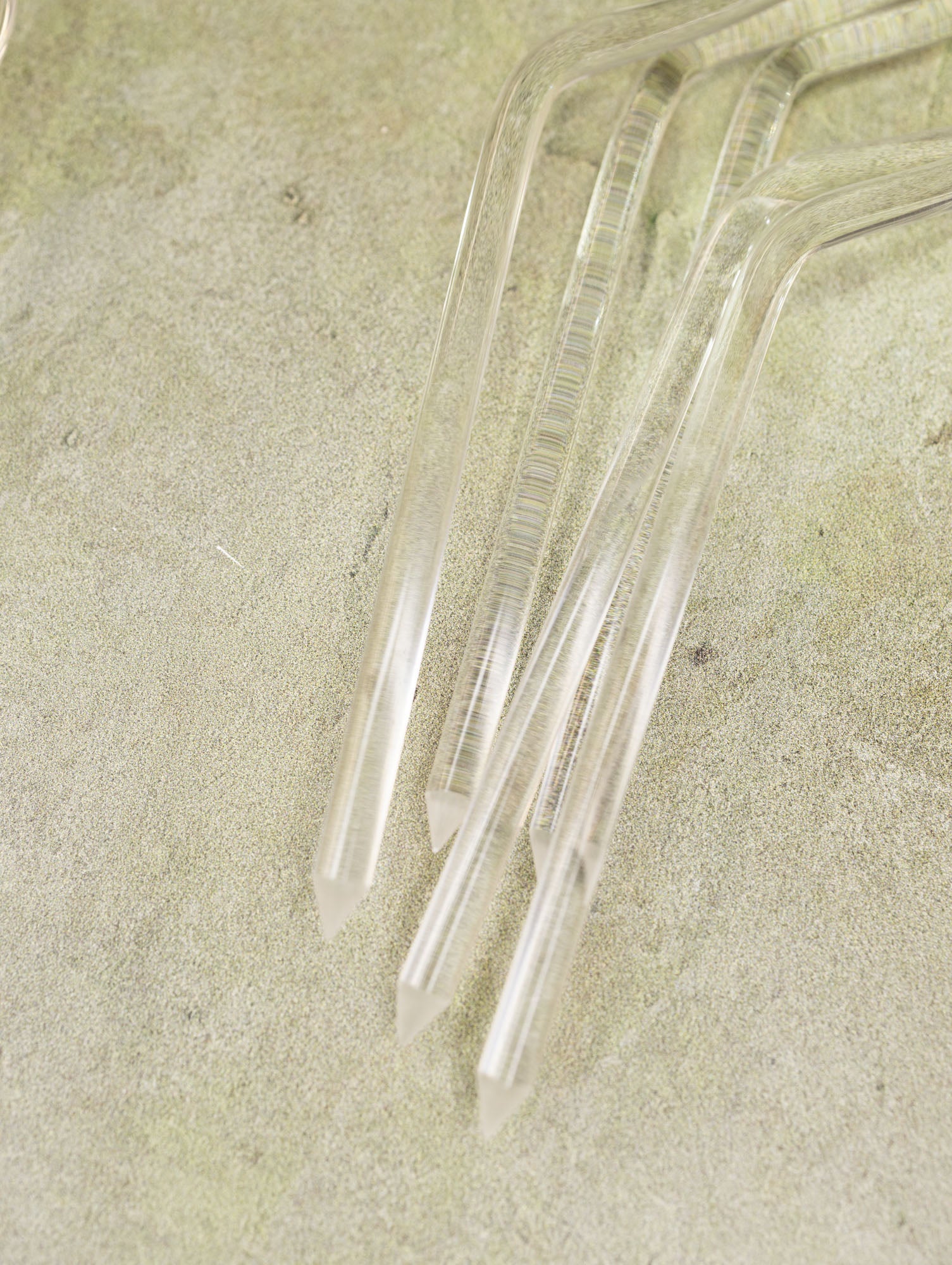 Clear acrylic trellises on a textured beige surface