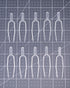 Clear plastic pins arranged on a grid-patterned surface