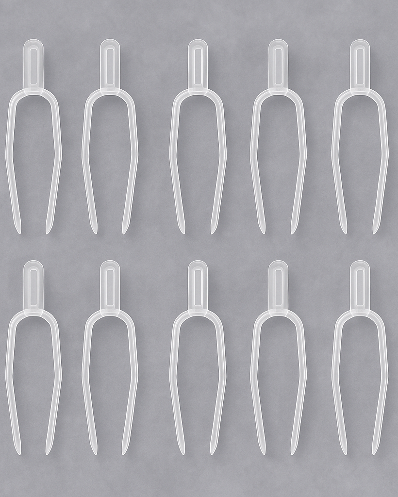 Set of clear plastic forks on a gray background