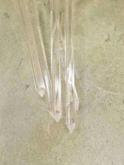 Clear crystal points on a beige sand background