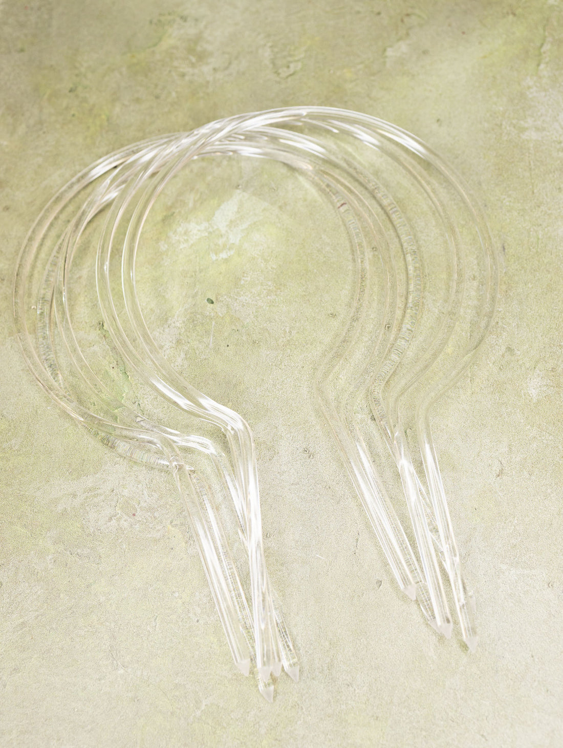 Clear acrylic trellises on a textured beige surface