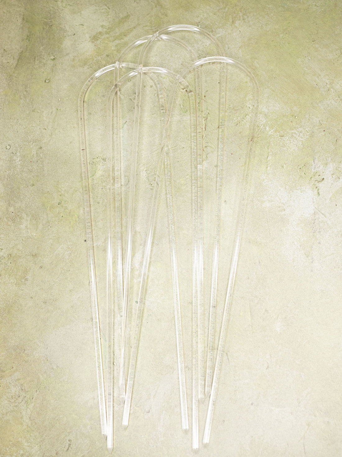 Clear acrylic u-shape trellis on a green background