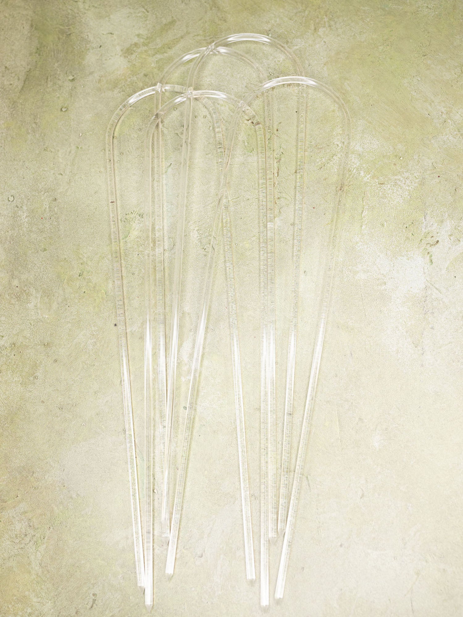 Clear acrylic u-shape trellis on a green background